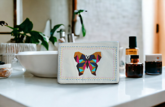 Tufted butterfly over white canvas utility bag