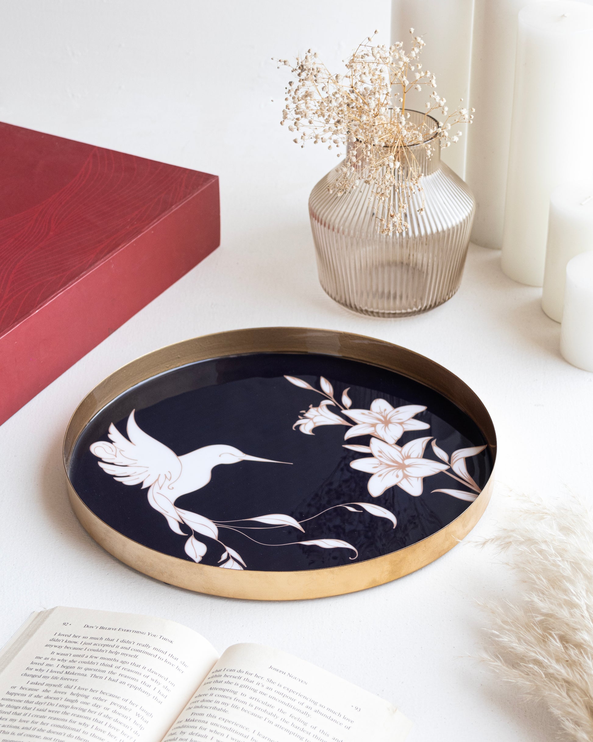 A stylish navy blue tray featuring a floral and hummingbird design, displayed on a chic table setting, ideal for home decor or gifting.